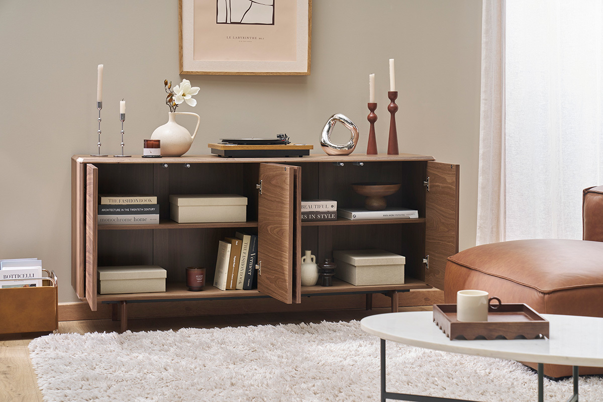 Buffet en noyer � portes ouvertes avec livres et objets d�coratifs.