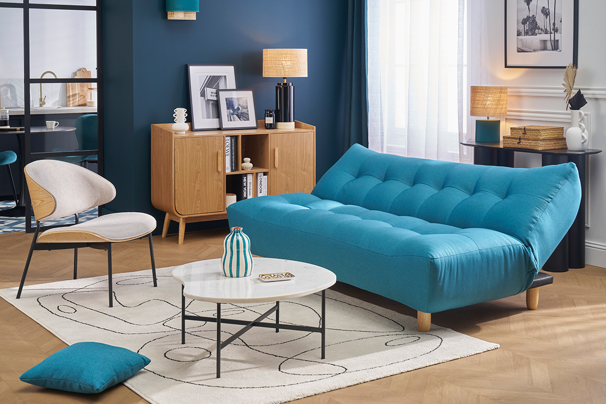 Canap� convertible bleu canard YUMI avec pieds en bois clair, dans un salon moderne.