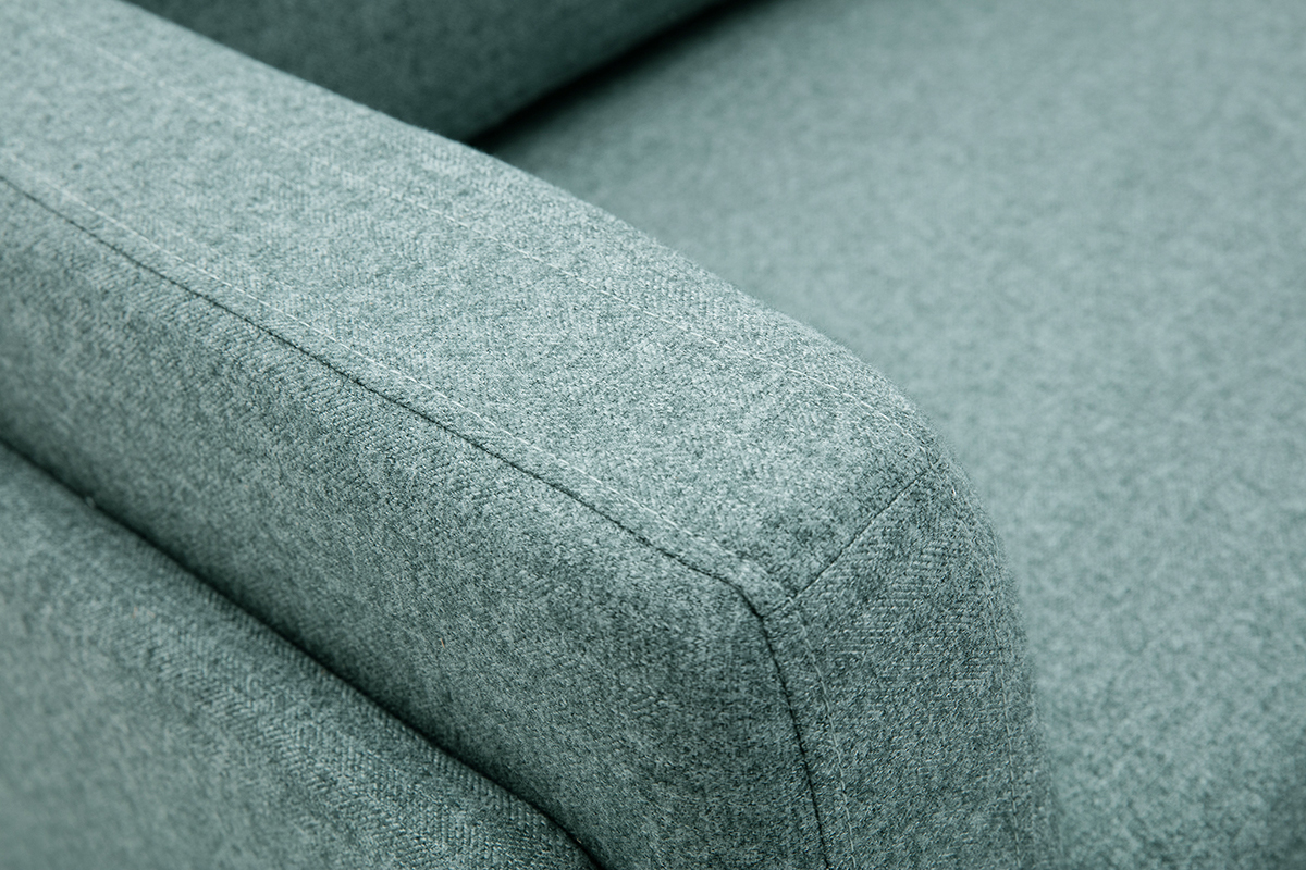 Accoudoir d'un canap� en tissu vert de gris vu en gros plan.