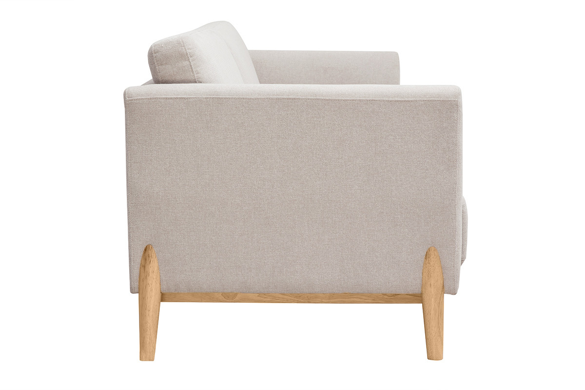 Canap� scandinave beige de profil avec pieds en bois clair, accoudoir visible.