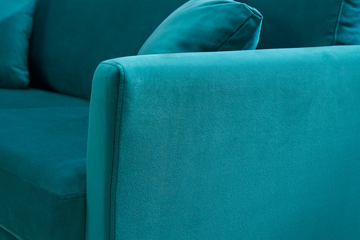 Accoudoir de canap� en velours bleu p�trole avec coussin.
