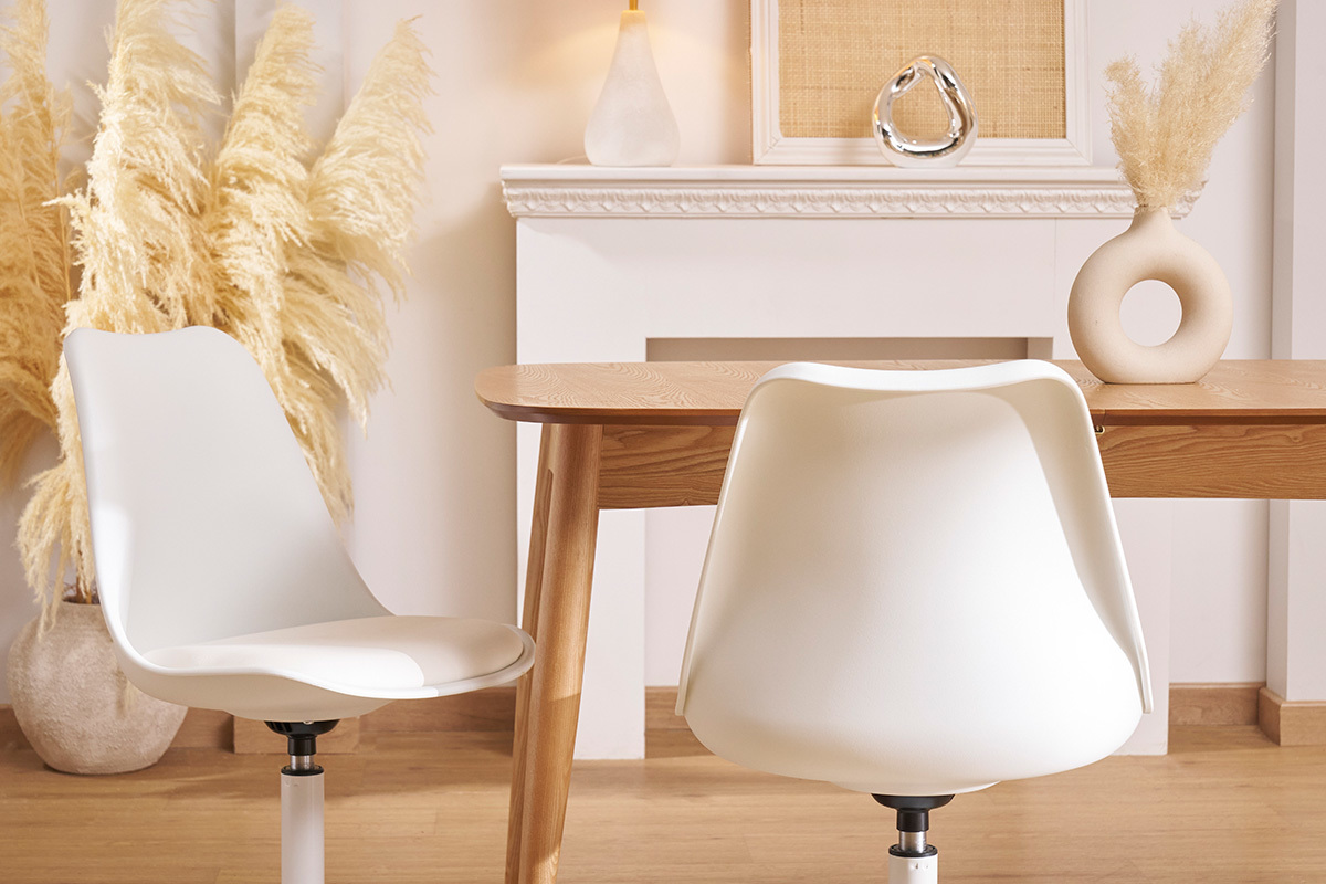 Deux chaises pivotantes blanches STEEVY V2 autour d'une table en bois clair.