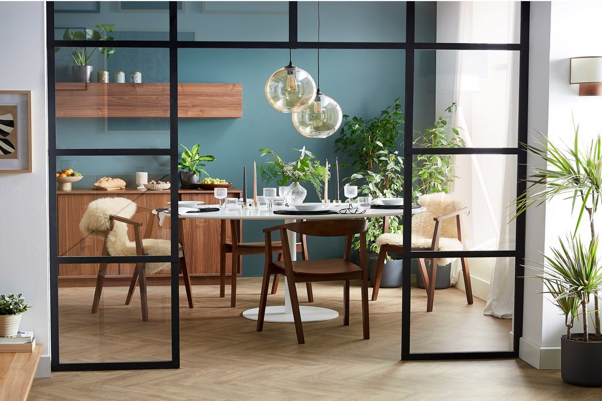 Chaises scandinaves en bois fonc� BAHIA dans une salle � manger moderne, vue de c�t�.