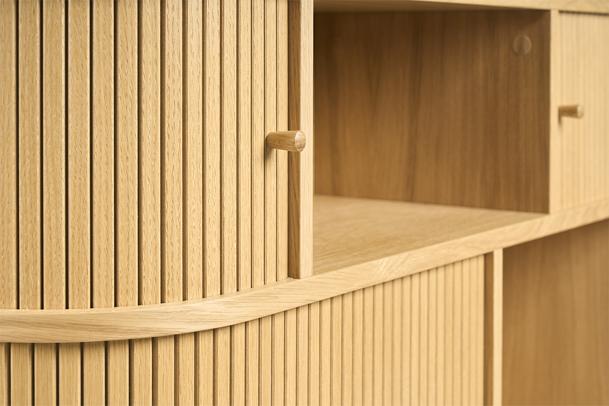 Gros plan sur une console en bois clair avec portes rainur�es et poign�es.