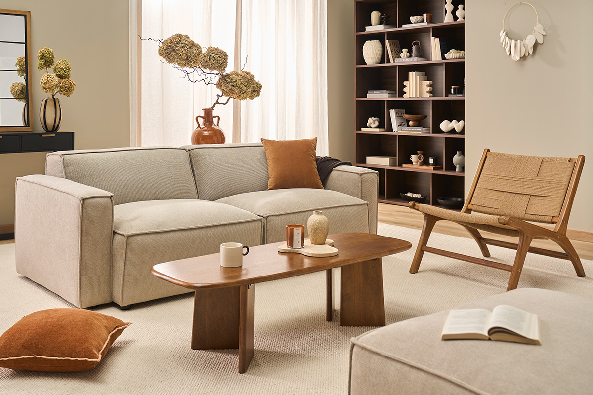 Salon avec fauteuil YARI en teck et corde tress�e, canap� beige et table basse en bois.