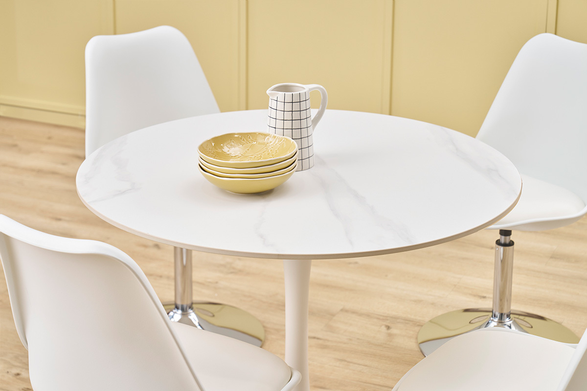 Table ronde en c�ramique blanche avec chaises et vaisselle, vue de dessus.