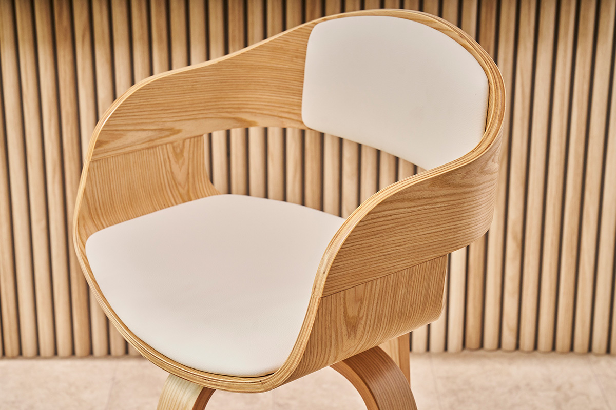 Tabouret de bar scandinave en bois clair avec si�ge blanc en gros plan.